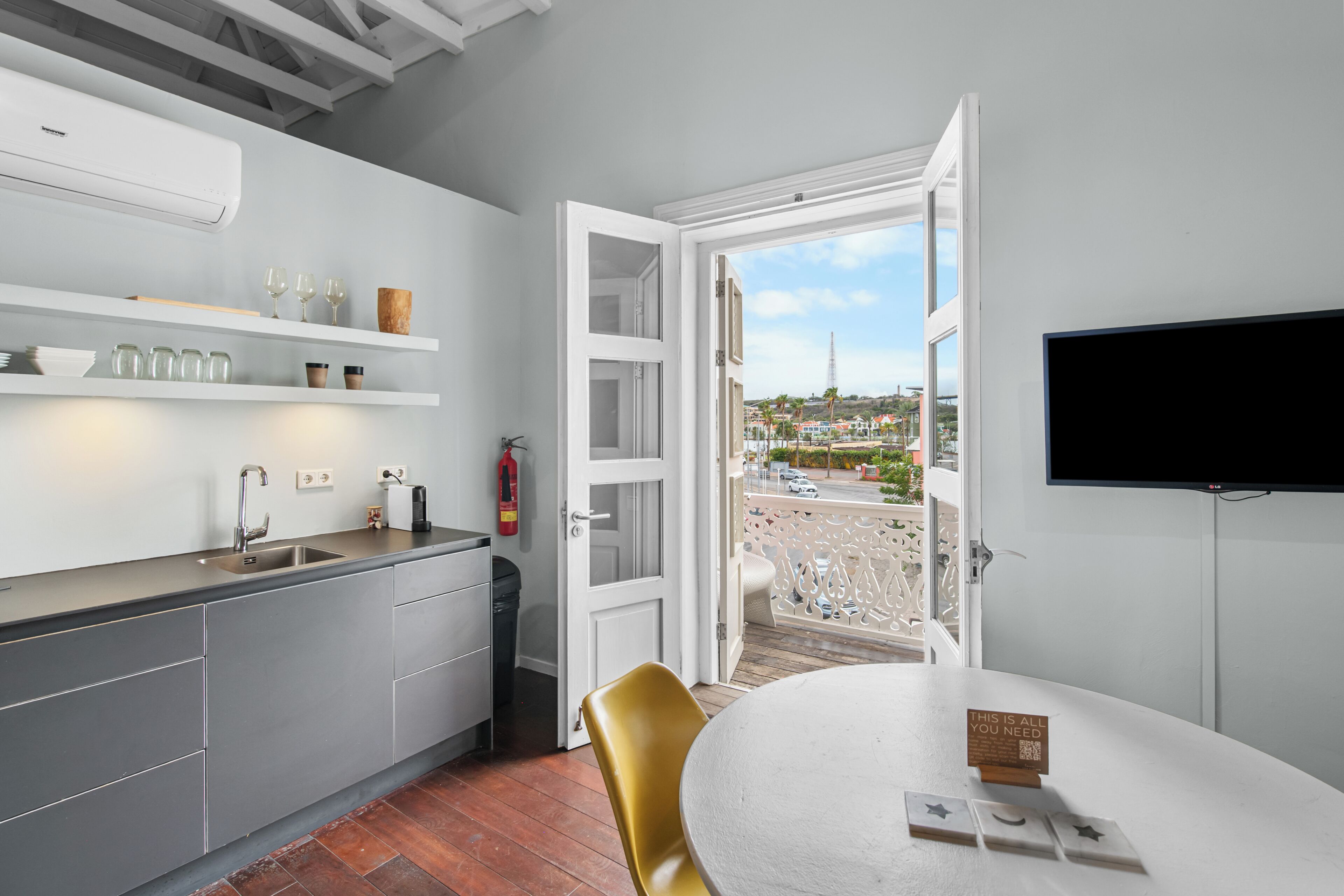 A modern kitchen with a view of a coastal town.