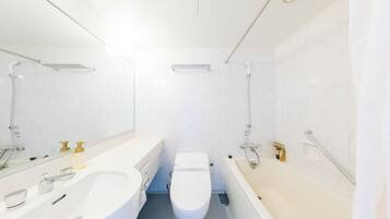 A modern bathroom with a white sink, toilet, and bathtub.