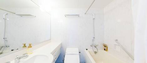 A modern bathroom with a white sink, toilet, and bathtub.