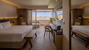 A hotel room with two beds, a desk, a chair, a small table, and a view of the beach. - Aranwa Paracas Resort & Spa (Paracas)