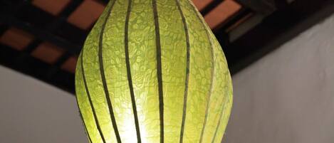 A hanging green lantern with a textured surface.