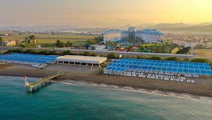 A coastal hotel with multiple solar panel arrays, a pier, and a large building with a helipad. - Crystal Admiral Aqua Collection - All inclusive (Manavgat)