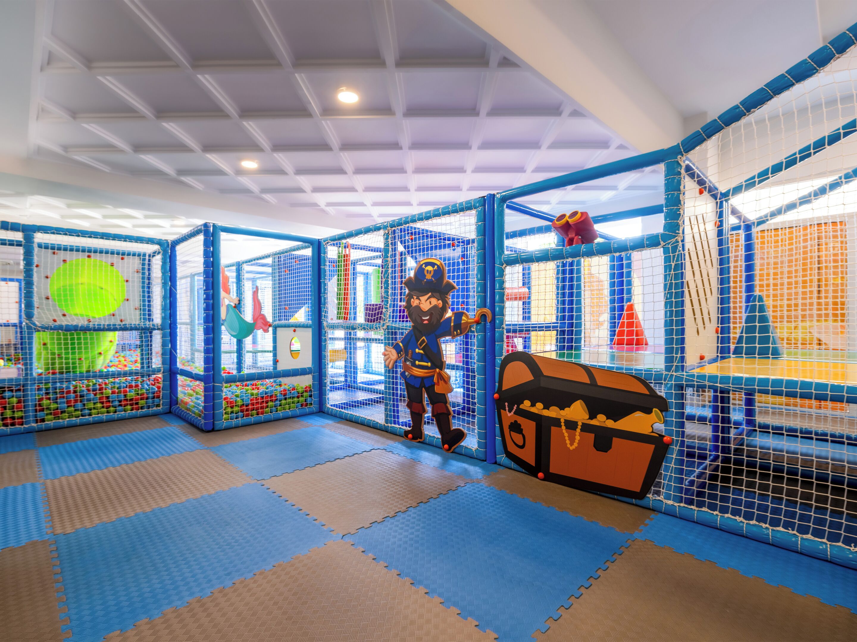 A play area with netted structures, a treasure chest, and a character figure.