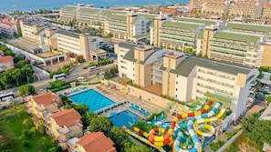 A hotel with multiple buildings, a swimming pool, and a water park. - Crystal Waterworld Aqua Collection (Serik)