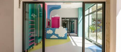 A colorful children's play area with a sign reading 'CRISPY KIDS WORLD' and a cartoon elephant logo.