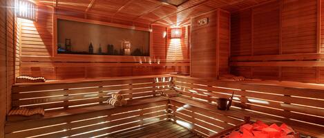 A sauna with wooden benches and a large mirror.