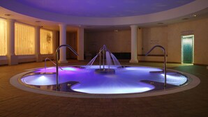 A large indoor pool with a central fountain, surrounded by columns and a tiled floor. - Whittlebury Hall Hotel & Spa (Towcester)