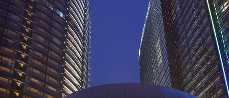 A modern building with a curved glass facade and a distinctive circular entrance.