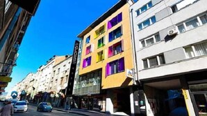 A multi-story building with a modern design, featuring large windows and a flat facade. - Colors Inn (Sarajevo)