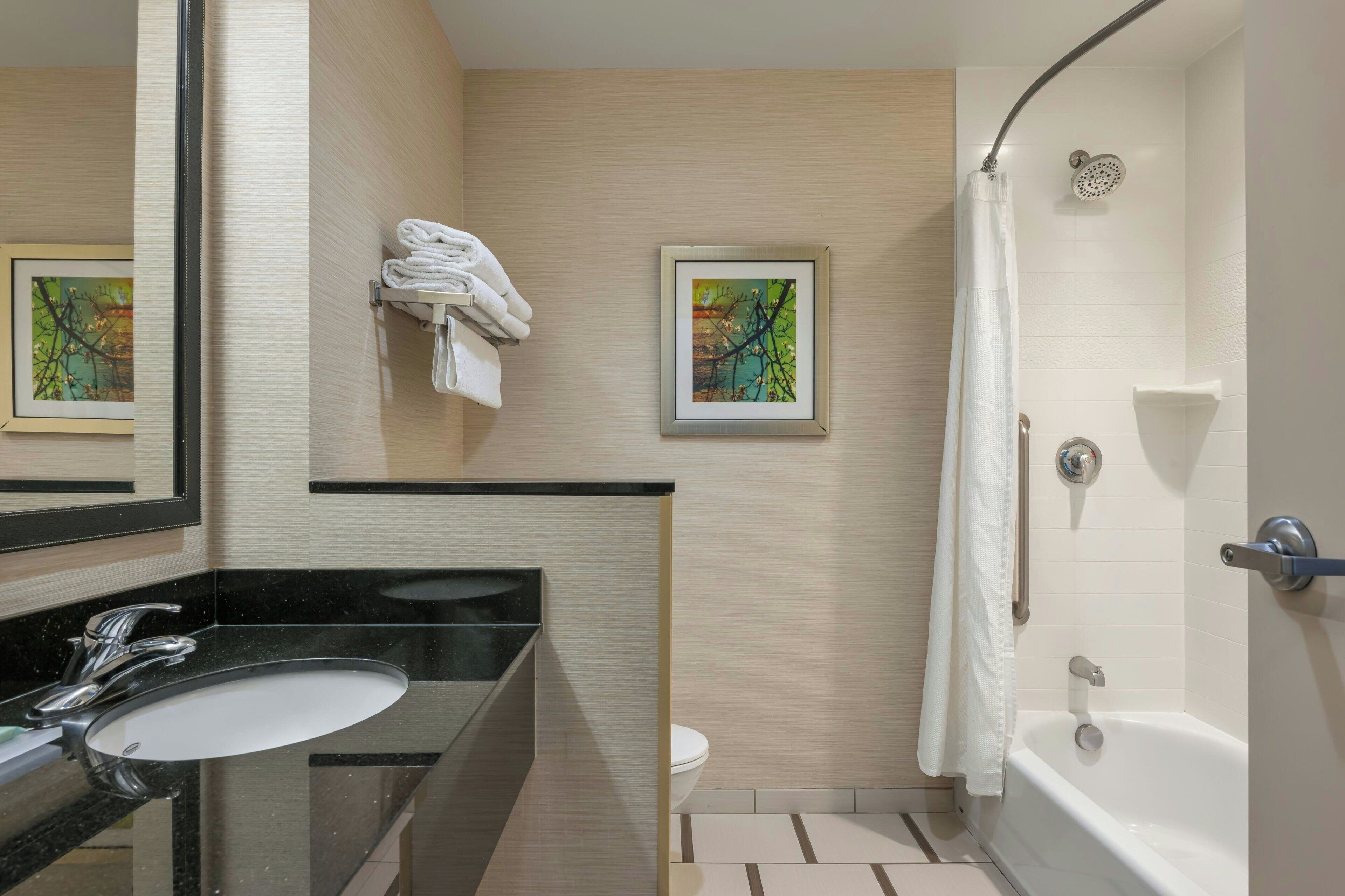 designer toiletries, hair dryer, towels, soap