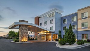 A Fairfield by Marriott hotel with a modern design, featuring a stone facade, multiple windows, and a well-lit entrance.