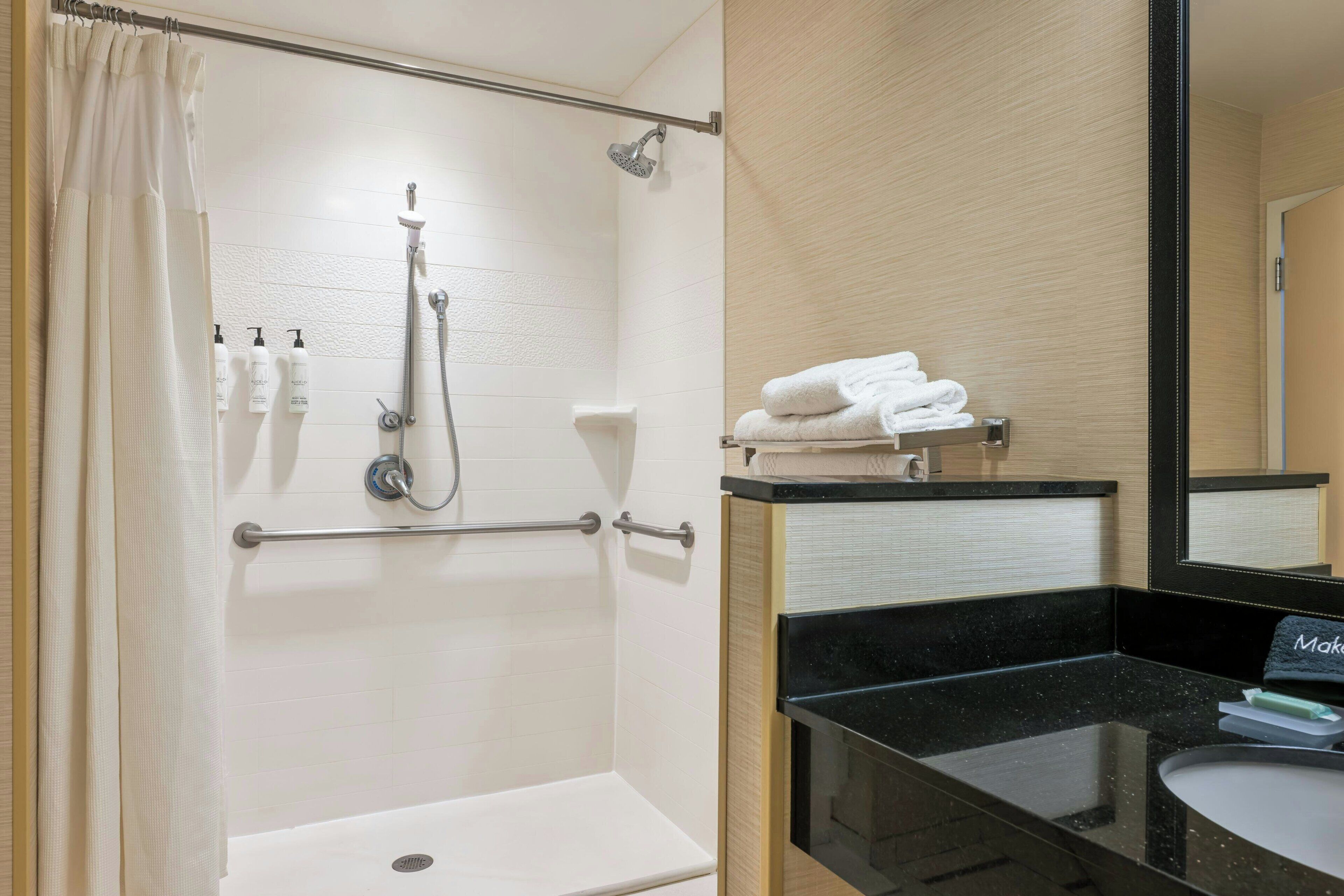 designer toiletries, hair dryer, towels, soap