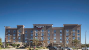 Experience the sleek design of this hotel, featuring a stone facade and multiple windows.