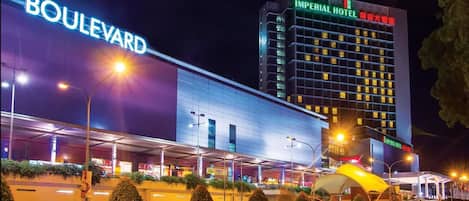 A modern hotel with a prominent 'Boulevard' sign and an 'Imperial Hotel' sign.
