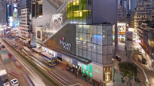 A modern high-rise building with a prominent 'Hysan Place' sign, featuring a glass facade and multiple floors with commercial spaces. - 9 Boutique Hotel (Hong Kong)