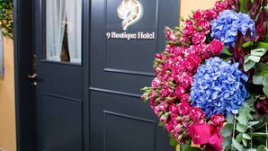 A black door with a logo and the name 'Boutique Hotel'. - 9 Boutique Hotel (Hong Kong)