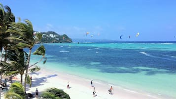 On the beach, white sand, sun-loungers, beach umbrellas