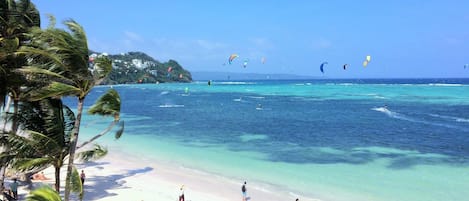 On the beach, white sand, sun loungers, beach umbrellas