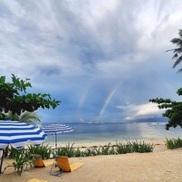 On the beach, white sand, sun loungers, beach umbrellas