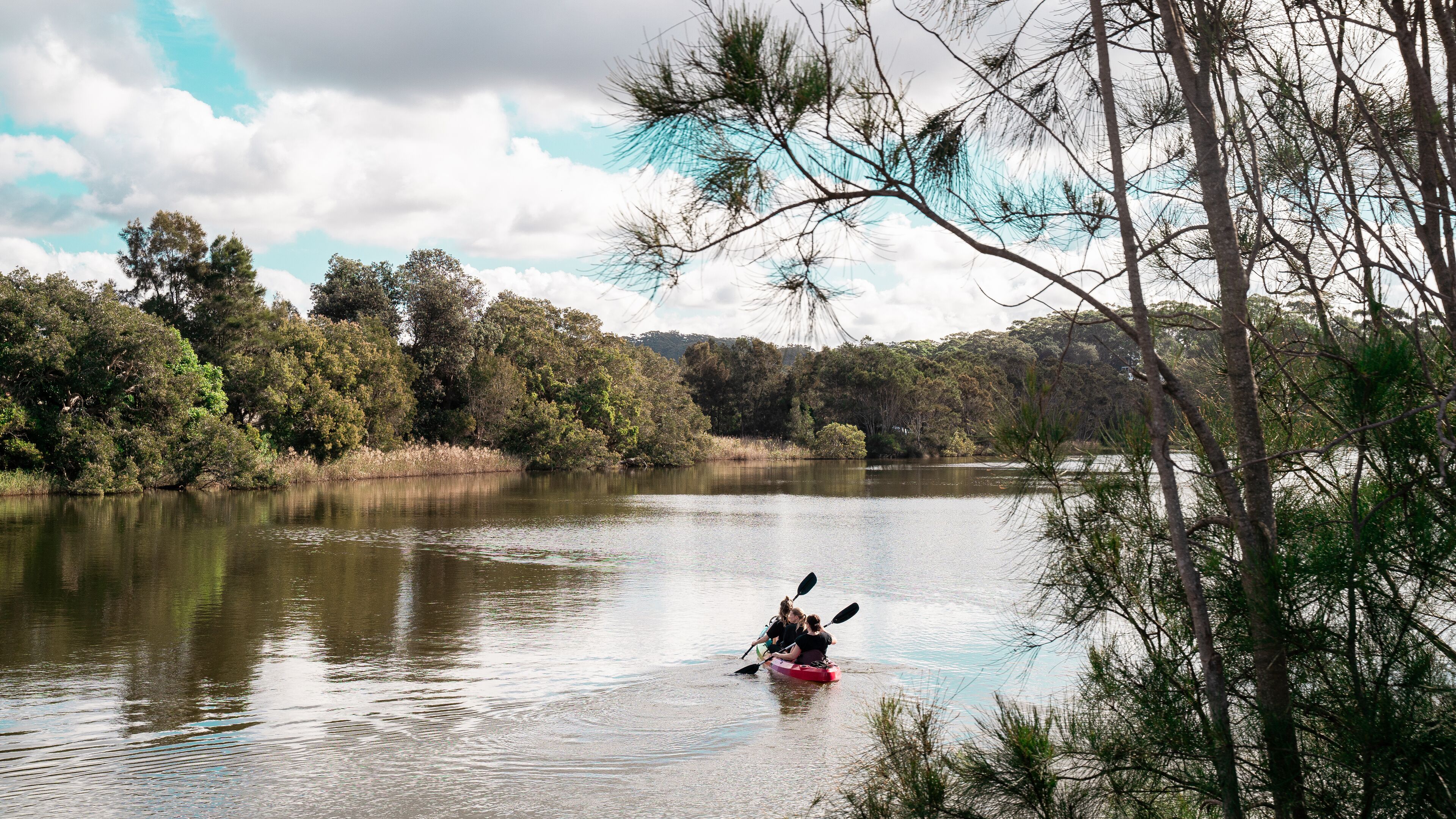 A calm lake with kayakers.