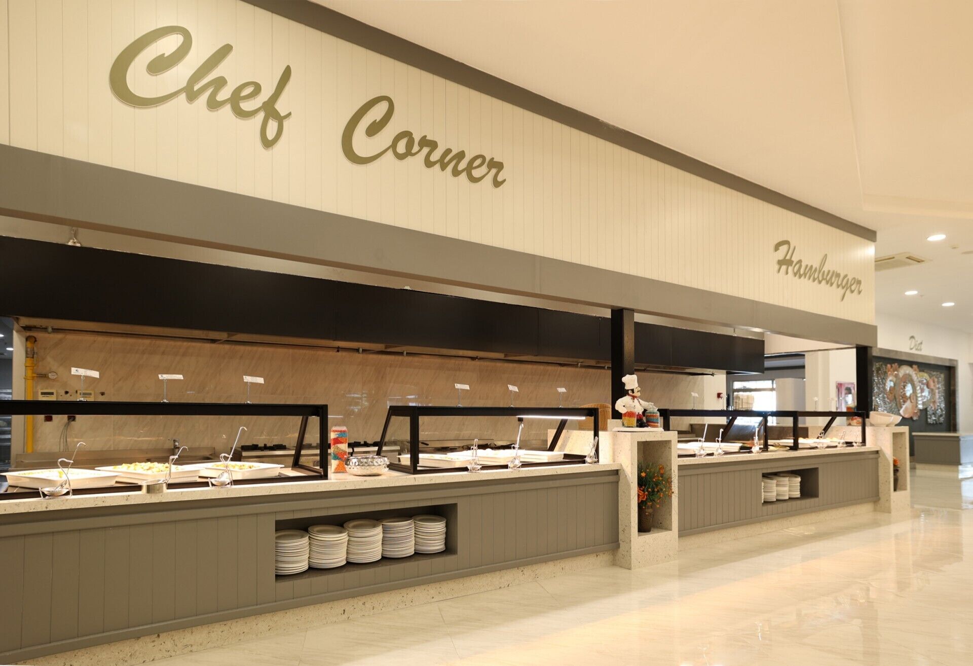 A buffet area with multiple serving stations, labeled 'Chef Corner' and 'Hamburger'.