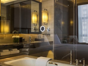 A modern bathroom with a large mirror, a sink, a toilet, and a shower area. - Pullman Weifang (Weifang)