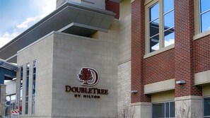 A DoubleTree by Hilton hotel with a prominent tree logo on the facade.