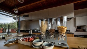 A kitchen with a wooden countertop, a coffee machine, and various food items. - Casa Arrigo (Linguaglossa)