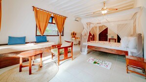 A bedroom with a bed, a bench, a daybed, and a wooden chair.