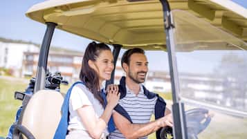 A golf cart with a driver and a passenger.
