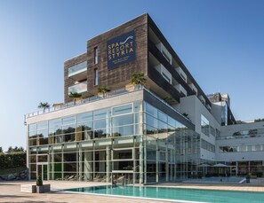 A modern building with a spa resort sign, large glass windows, and a pool area. - Spa Resort Styria - Adults Only (Bad Waltersdorf)