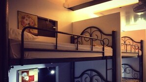 A bunk bed room with a framed picture on the lower bunk. - At Phangan Hostel (Ko Pha-ngan)