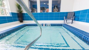 An indoor swimming pool with blue tiled walls and a clear water surface. - Holiday Inn Express & Suites Spruce Grove - Stony Plain by IHG (Spruce Grove)
