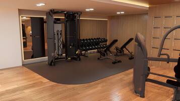 A modern gym with exercise equipment, a mirrored wall, and wooden flooring.