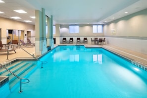 Relax by the pool, surrounded by a spacious deck and lounge chairs.