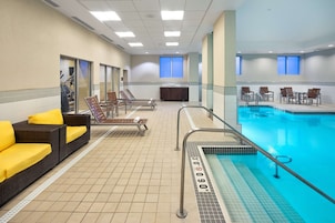 Una piscina techada, sillones reclinables de piscina