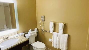 A bathroom with a toilet, sink, and towel rack.