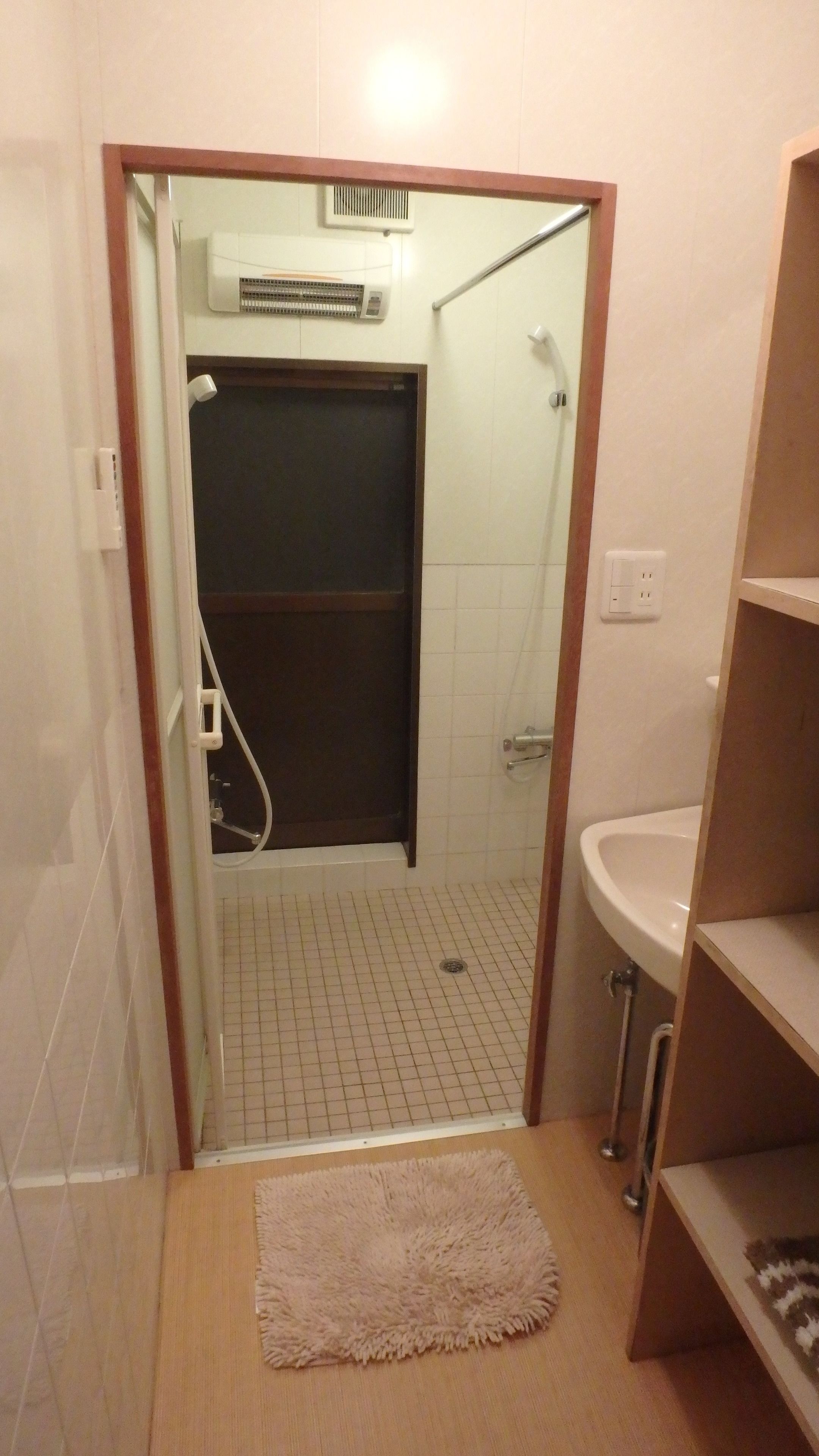 A small bathroom with a shower, a toilet, and a sink.