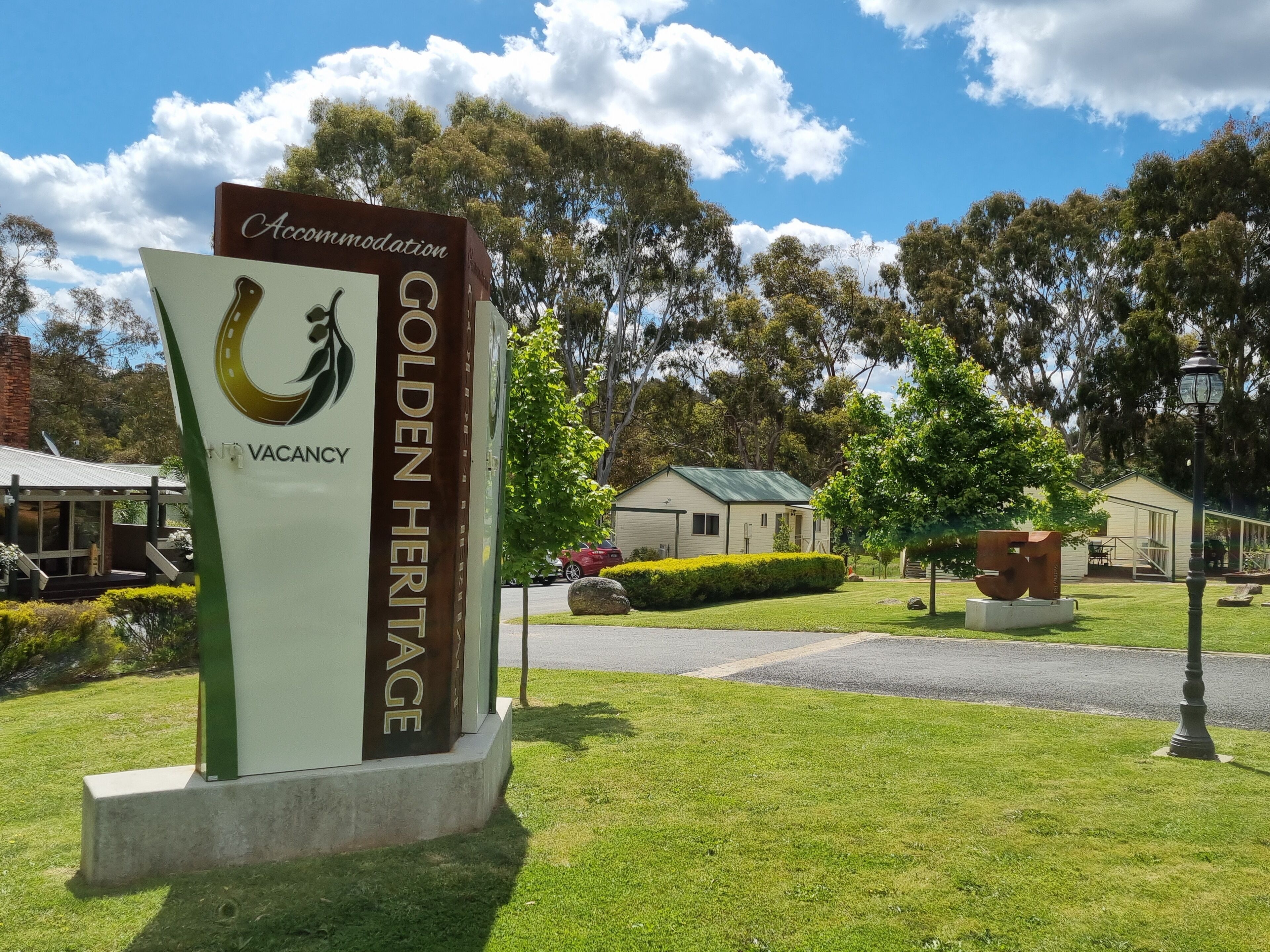 A sign for Golden Heritage Accommodation with a vacancy notice.