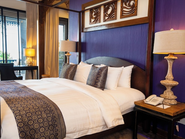 A hotel room with a large bed, a bedside table with a lamp, a phone, and a decorative wall panel. - Ombak Villa Langkawi (Langkawi)