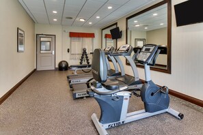 A fitness center with treadmills, a stationary bike, and a weight bench. - Holiday Inn Express Cheektowaga North East by IHG (Buffalo)