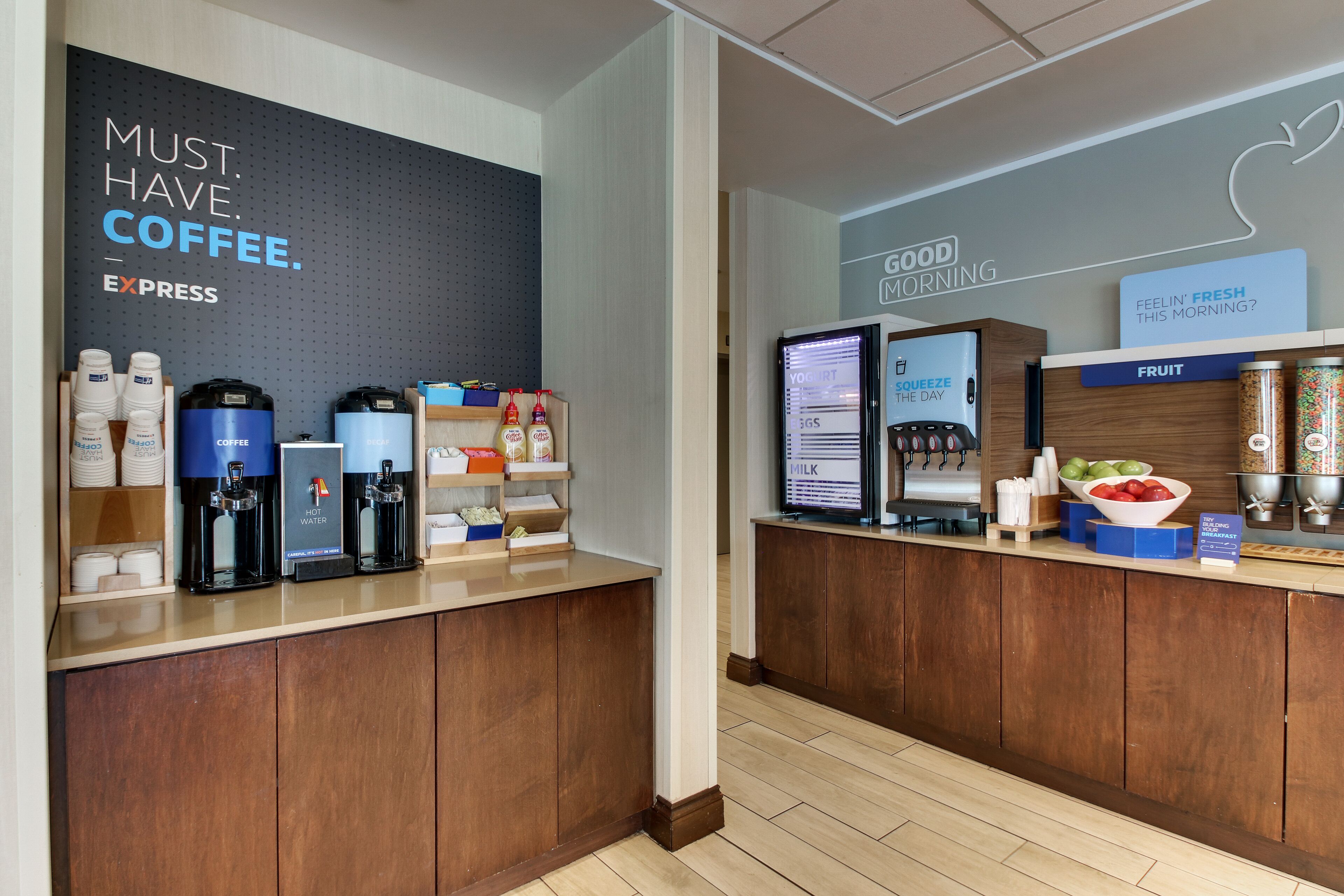 A coffee station with multiple coffee dispensers and a digital screen displaying menu options.