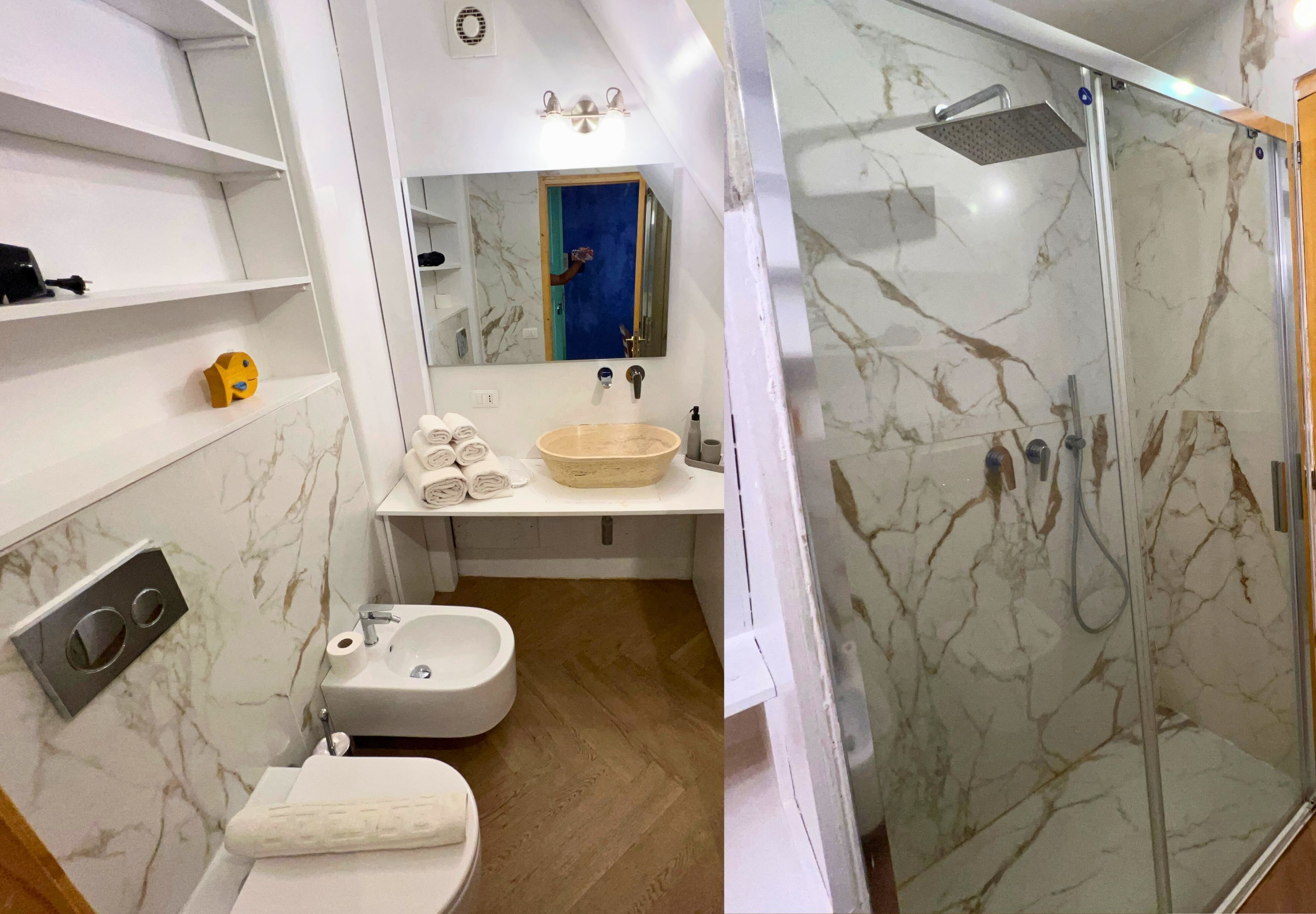A bathroom with a marble sink, a toilet, a shower with a glass door, and a mirror above the sink.