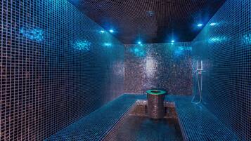 A modern, enclosed bathroom with a grid-patterned floor and walls, a central sink, and a shower area.