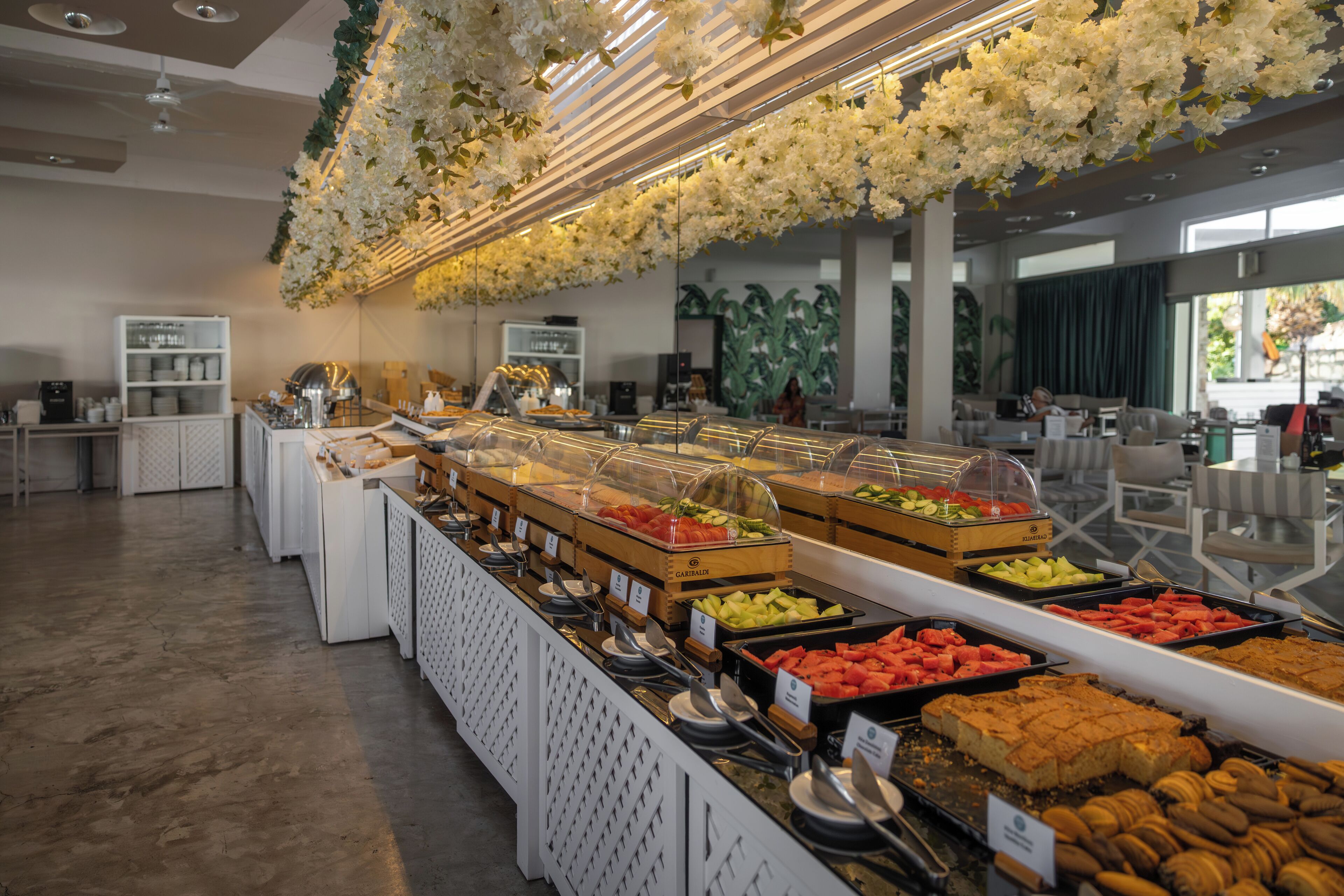 A buffet area with various food stations and a modern interior design.