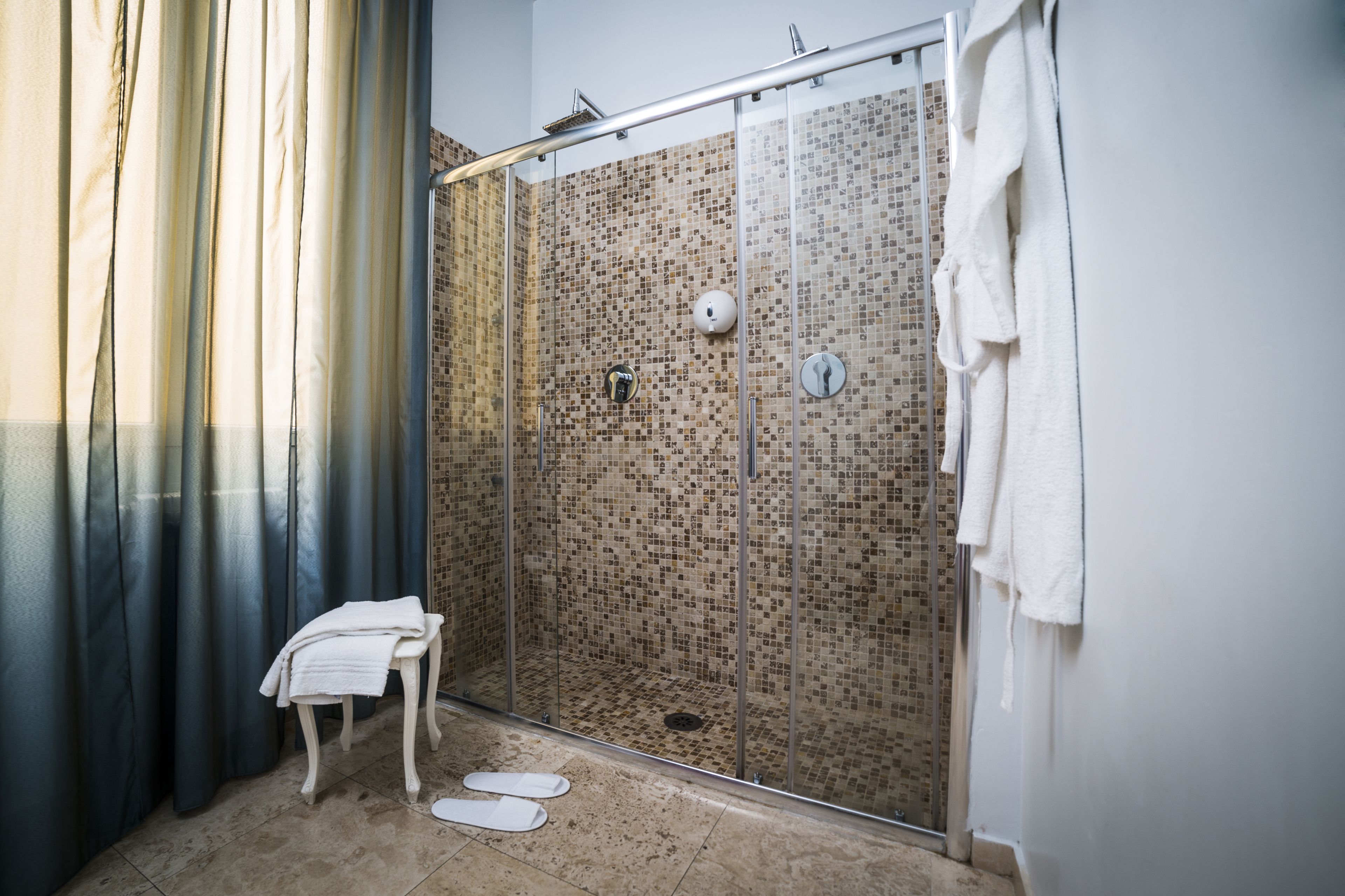 deluxe room | bathroom | shower, hydromassage showerhead, free toiletries, hair dryer