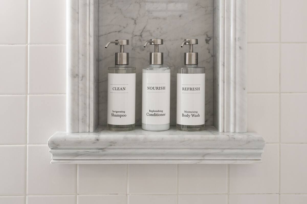 room, 2 queen beds | bathroom | combined shower/bathtub, eco-friendly toiletries, hair dryer, towels