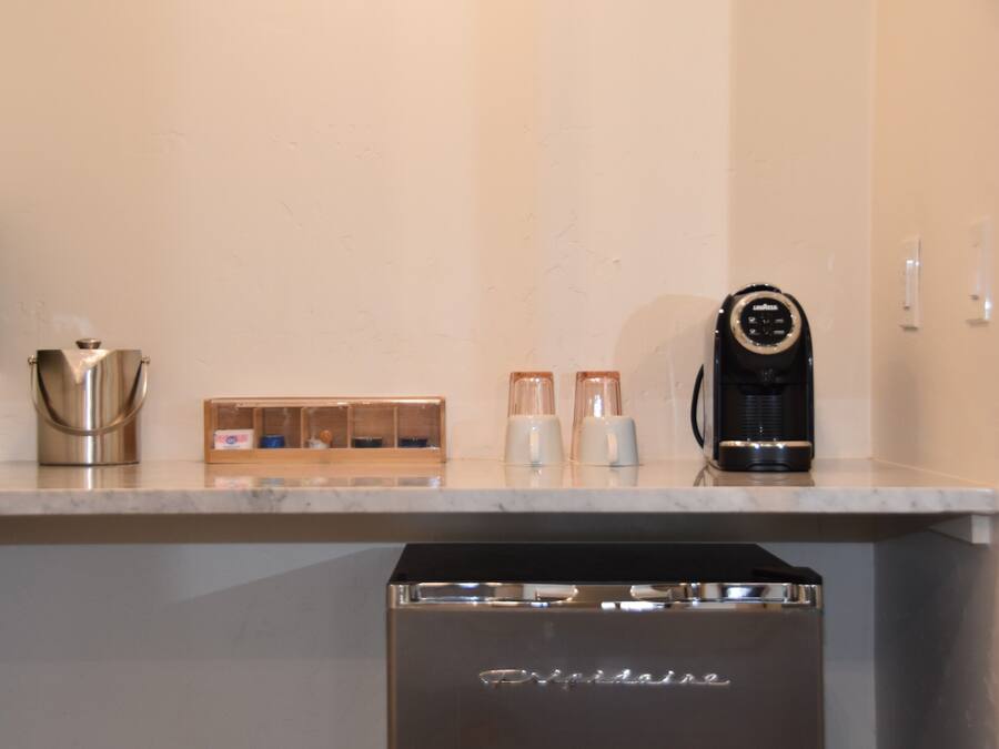 A kitchen with a coffee maker, a blender, and a dishwasher.