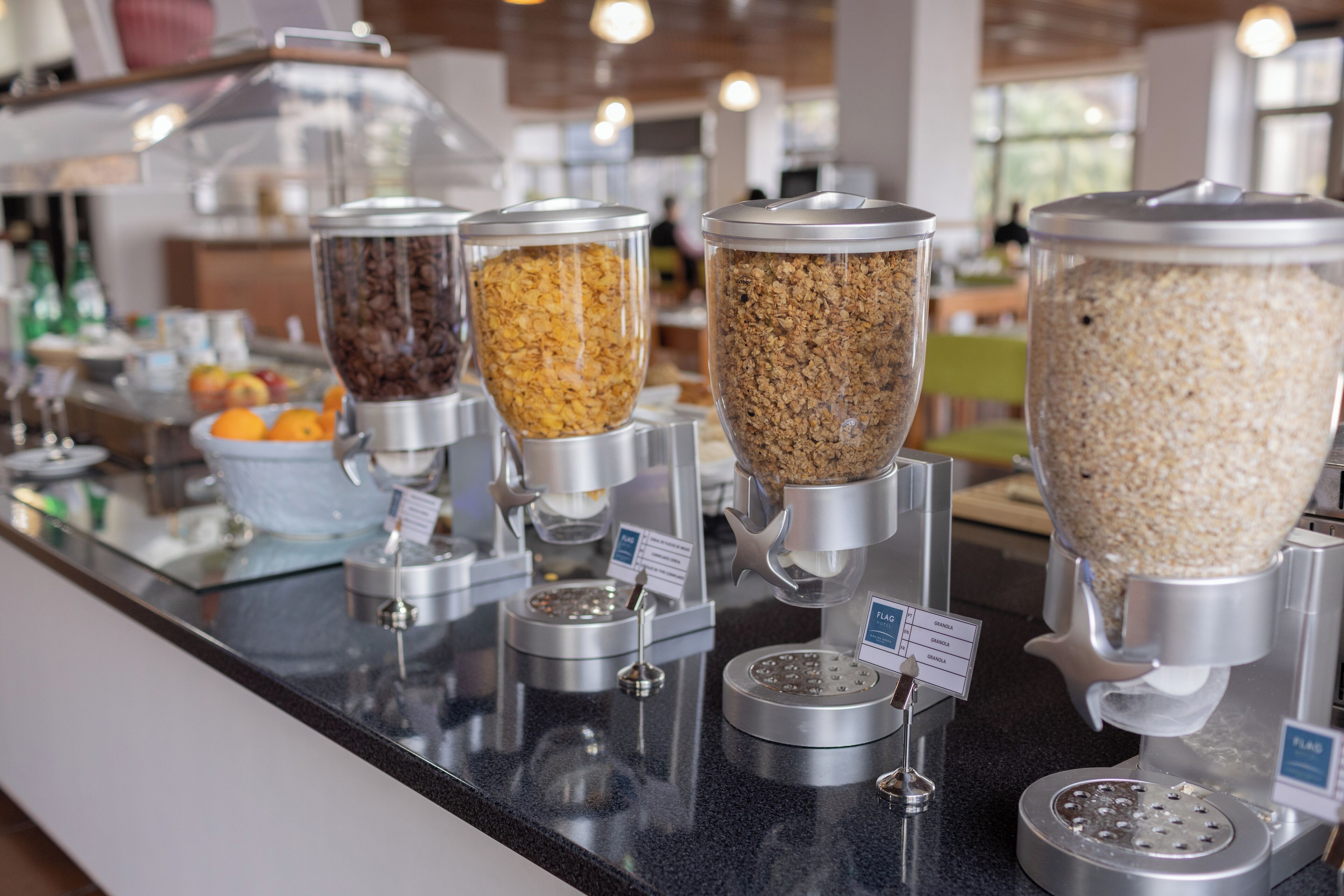 A coffee station with dispensers for different types of coffee and grains.