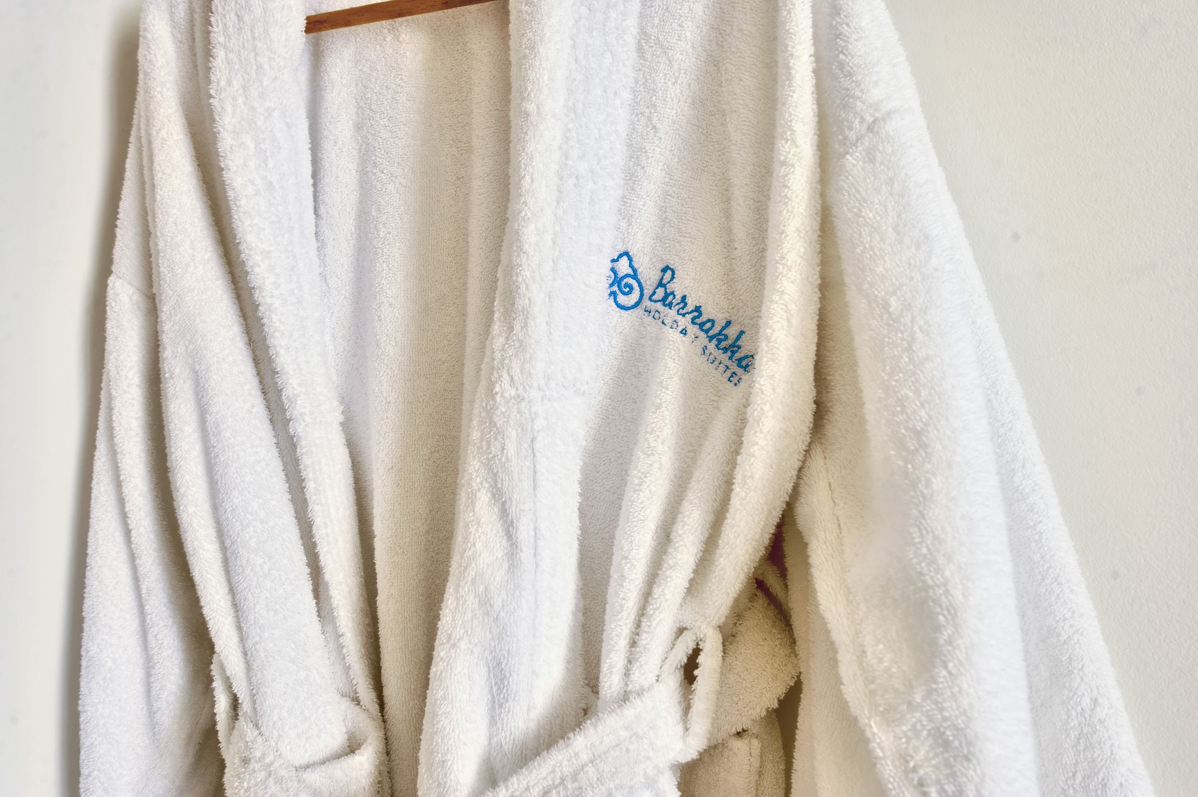 A white towel with a logo and text indicating it is from Barrakba.